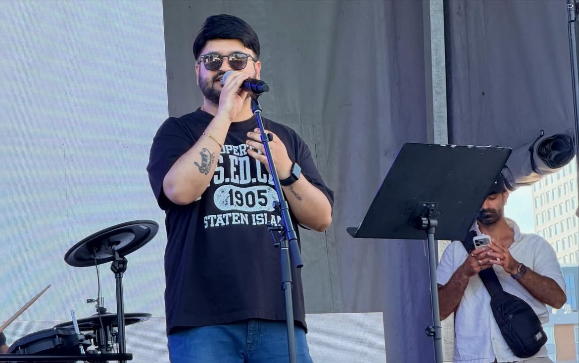 Abhiram Yerramilli singing into a microphone on stage
