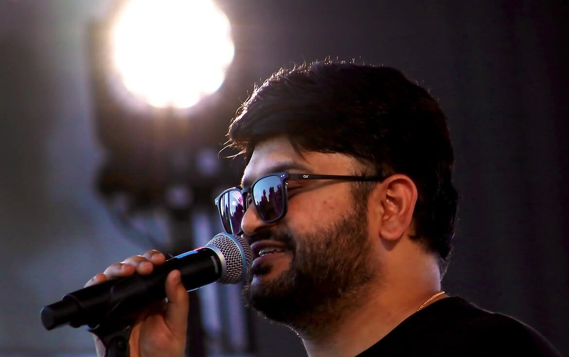 Abhiram Yerramilli singing into a microphone on stage