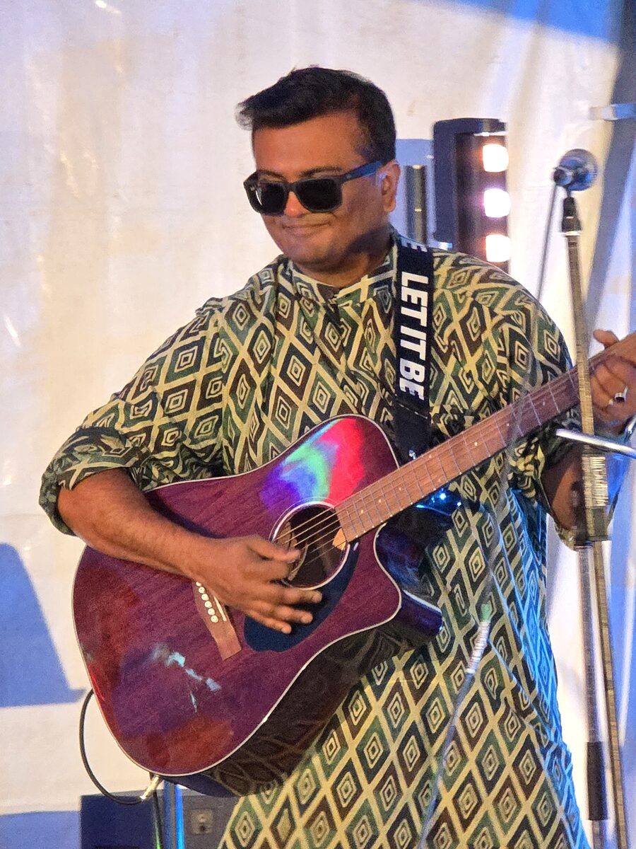 Kaustav Chakrabarty performing with an acoustic guitar on stage